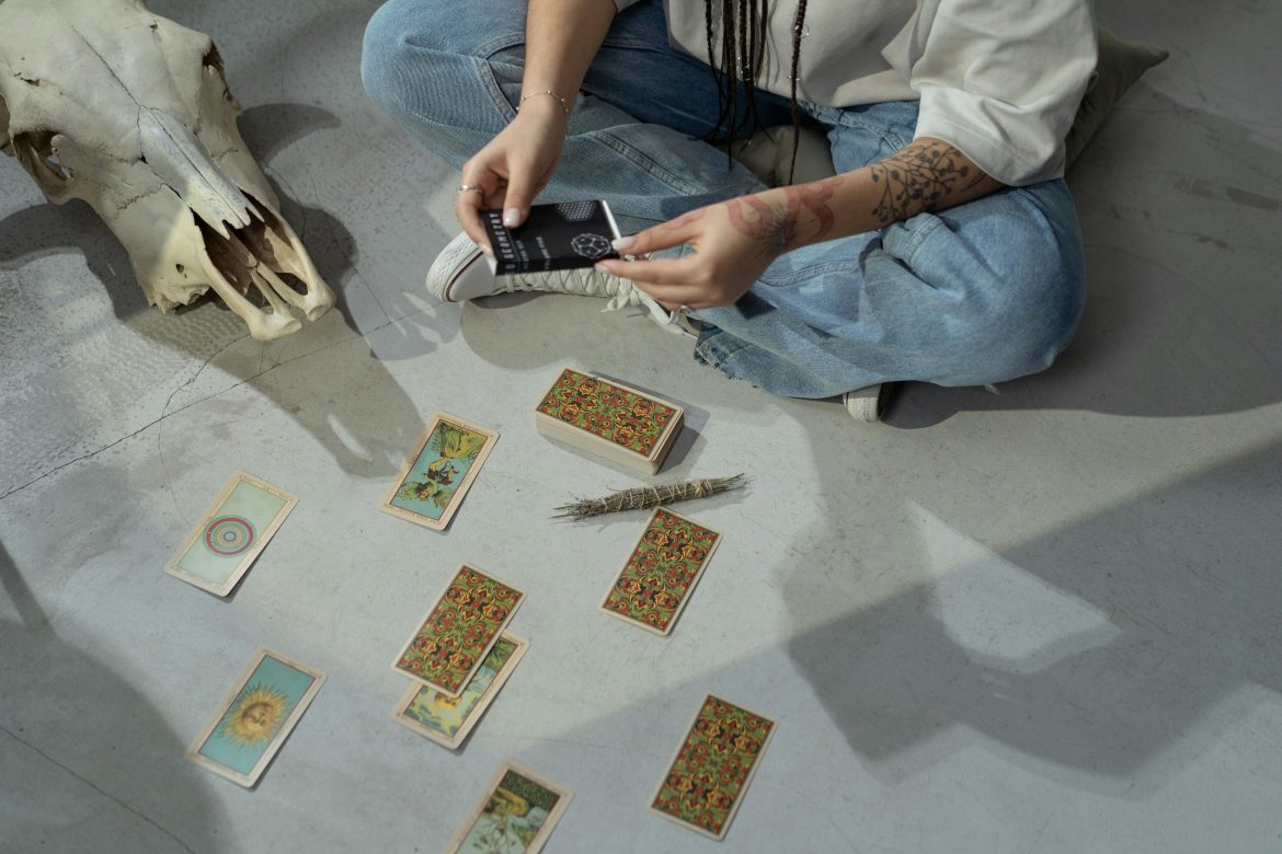 Person doing tarot reading on the floor
