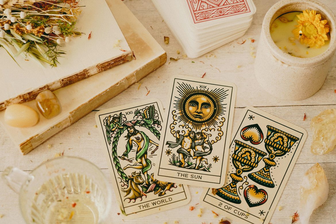 Tarot cards on wooden table with candle
